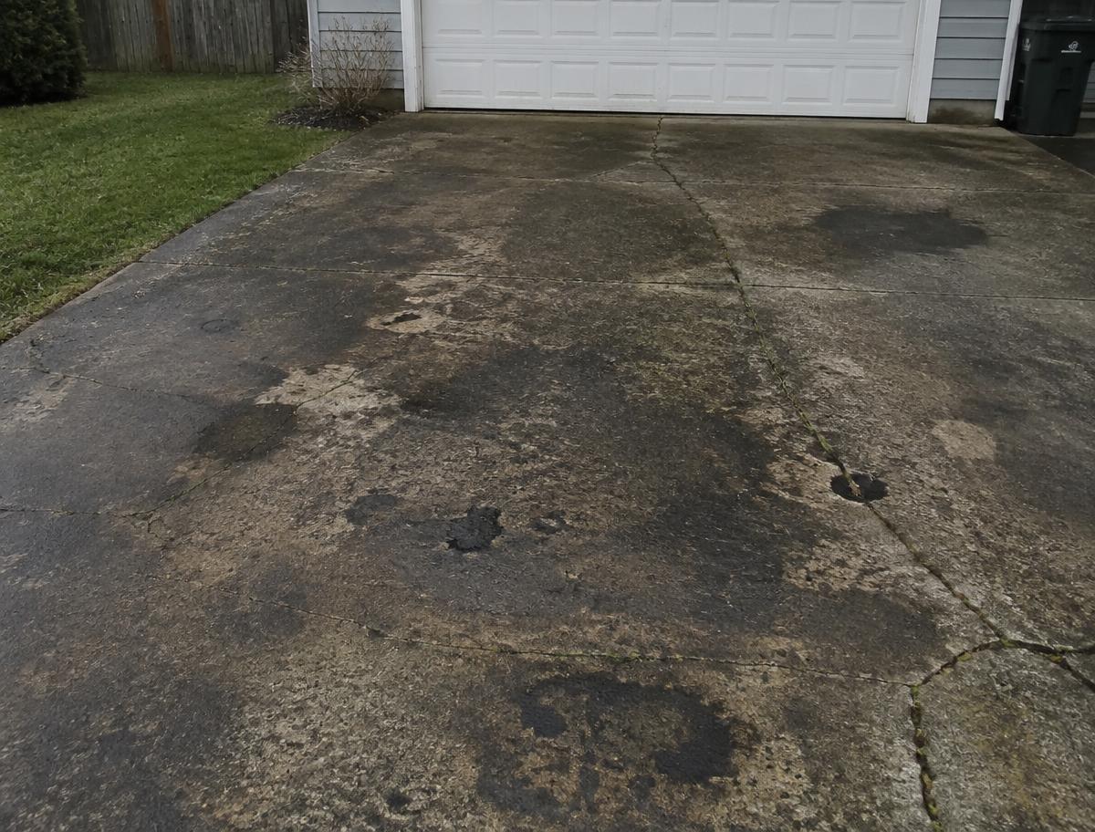 Stained driveway before cleaning